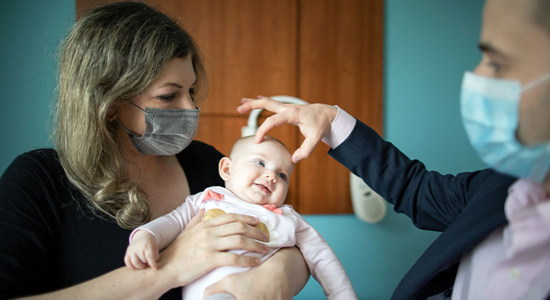 Image of doctor examining baby